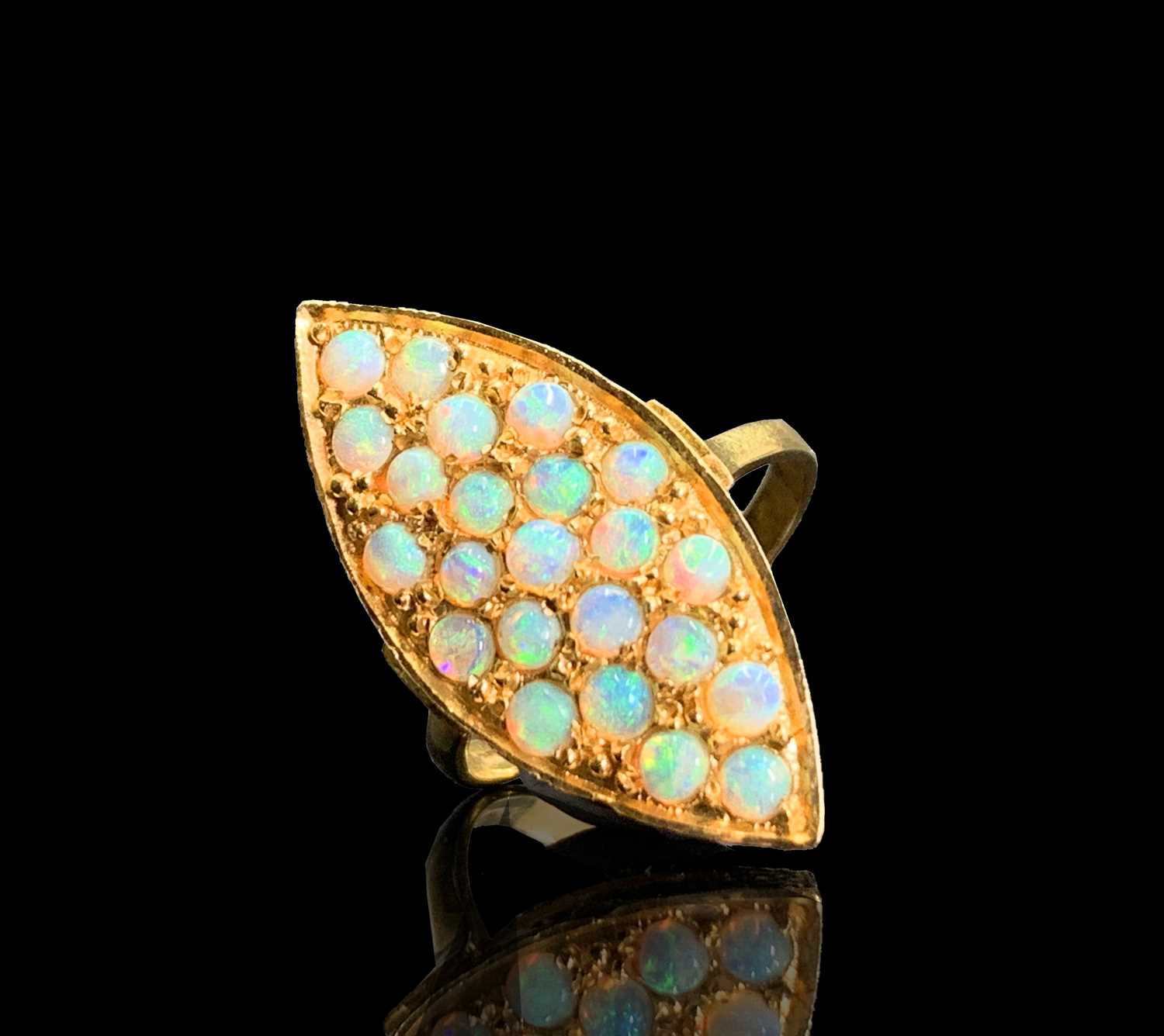Lot 165 - An 18ct gold navette ring, pave set with opals...