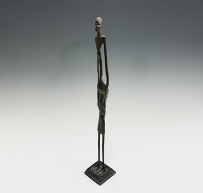 Lot 363 - An African bronze figure of elongated form,...