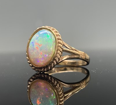 Lot 39 - Three gold rings each set an oval opal 8.5gm