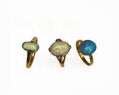 Lot 255 - Three gold rings each with an oval opal 7.9gm