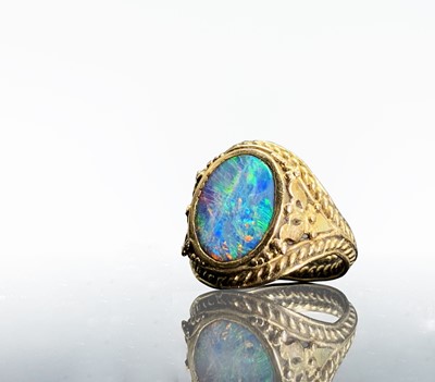 Lot 31 - A gold ring with an opal in ornate pierced and...