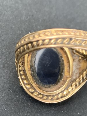 Lot 31 - A gold ring with an opal in ornate pierced and...