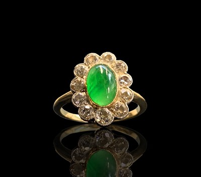 Lot 18 - A cabochon emerald and diamond oval cluster...