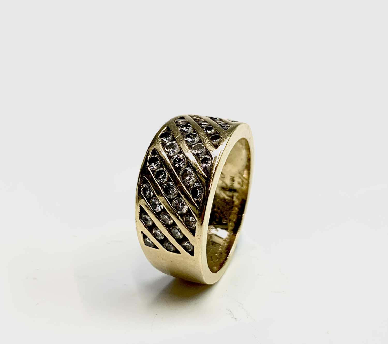 Lot 206 - An 18ct gold ring set with diagonal bands of...