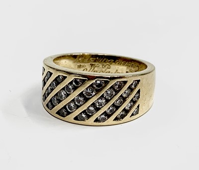 Lot 206 - An 18ct gold ring set with diagonal bands of...