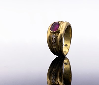 Lot 128 - An 18ct broad ruby-set ring with diamond line...