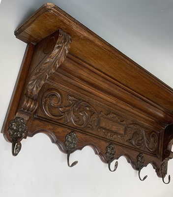 Lot 193 - A carved oak wall mounted coat rack, 19th...