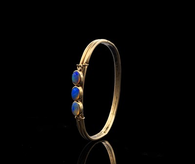 Lot 432 - A 9ct sprung core bangle mounted with three...