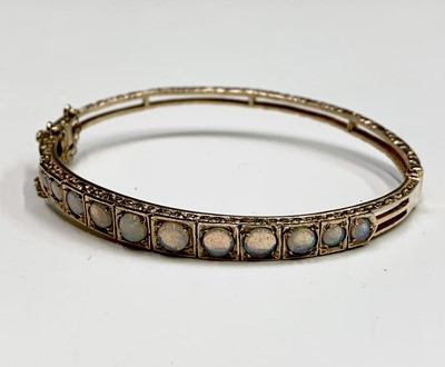 Lot 395 - A 9ct gold ornate hinged bangle set with...