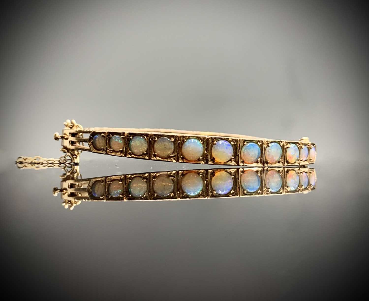 Lot 395 - A 9ct gold ornate hinged bangle set with...