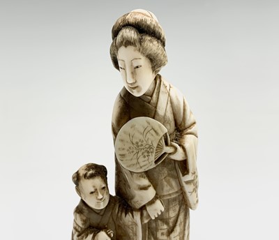Lot 20 - A Chinese carved ivory group of a mother and...