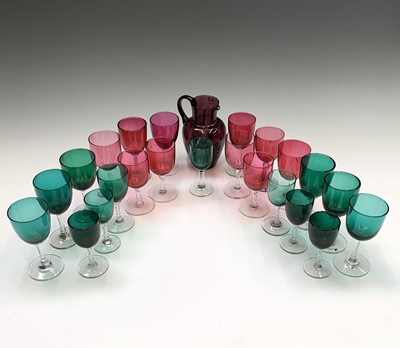 Lot 1082 - A group of 22 cranberry and green glass wines...