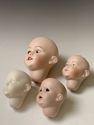 Lot 780 - Dolls - A box containing spare porcelain heads...