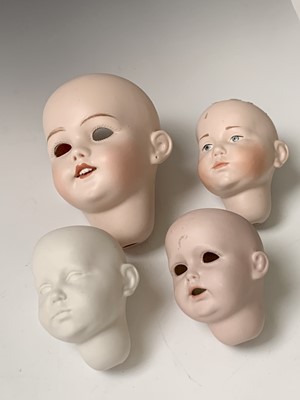Lot 780 - Dolls - A box containing spare porcelain heads...