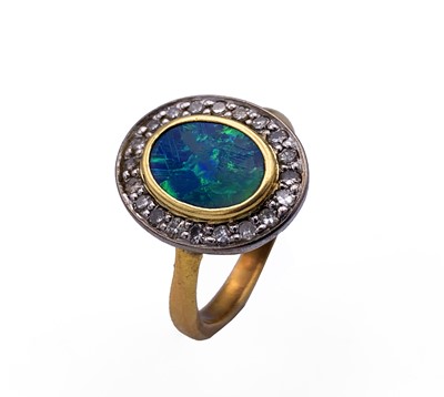Lot 387 - A 22ct gold diamond and opal oval cluster ring...