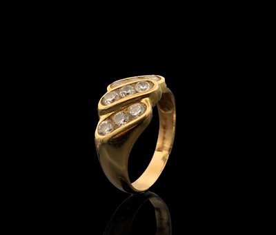 Lot 130 - A 9ct gold buckle ring set with red stones and...