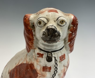 Lot 1091 - Two Victorian Staffordshire spaniel ornaments....