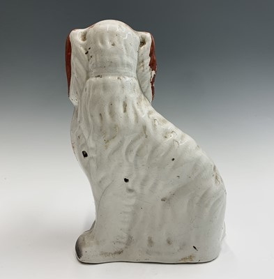 Lot 1091 - Two Victorian Staffordshire spaniel ornaments....