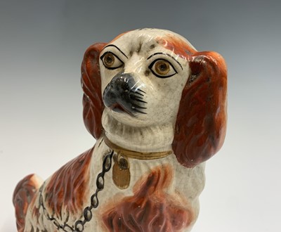 Lot 1091 - Two Victorian Staffordshire spaniel ornaments....