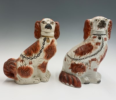 Lot 1091 - Two Victorian Staffordshire spaniel ornaments....