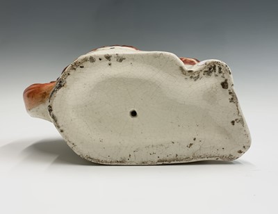 Lot 1091 - Two Victorian Staffordshire spaniel ornaments....