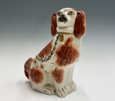 Lot 1091 - Two Victorian Staffordshire spaniel ornaments....