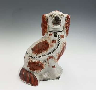 Lot 1091 - Two Victorian Staffordshire spaniel ornaments....