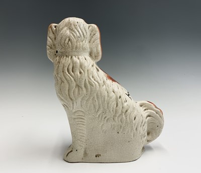 Lot 1091 - Two Victorian Staffordshire spaniel ornaments....
