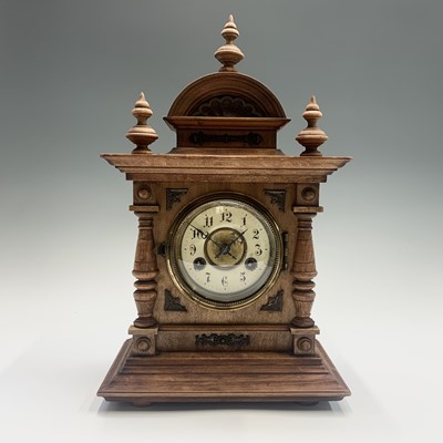 Lot 2931 - A German walnut and metal mounted mantel clock,...