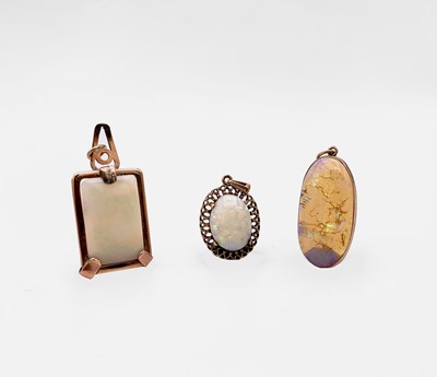 Lot 338 - Three gold-mounted opal pendants 15.6gm