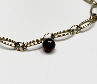 Lot 38 - A 9ct gold bracelet with seven garnet beads 4.7gm