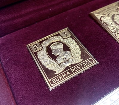 Lot 1016 - A set of 25 silver gilt replica stamps.