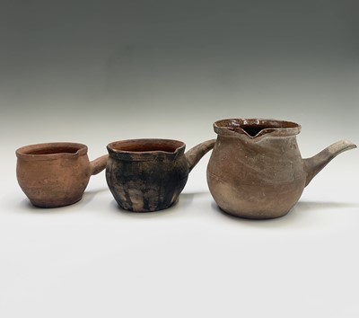 Lot 1100 - Three 19th century earthenware pipkins. The...