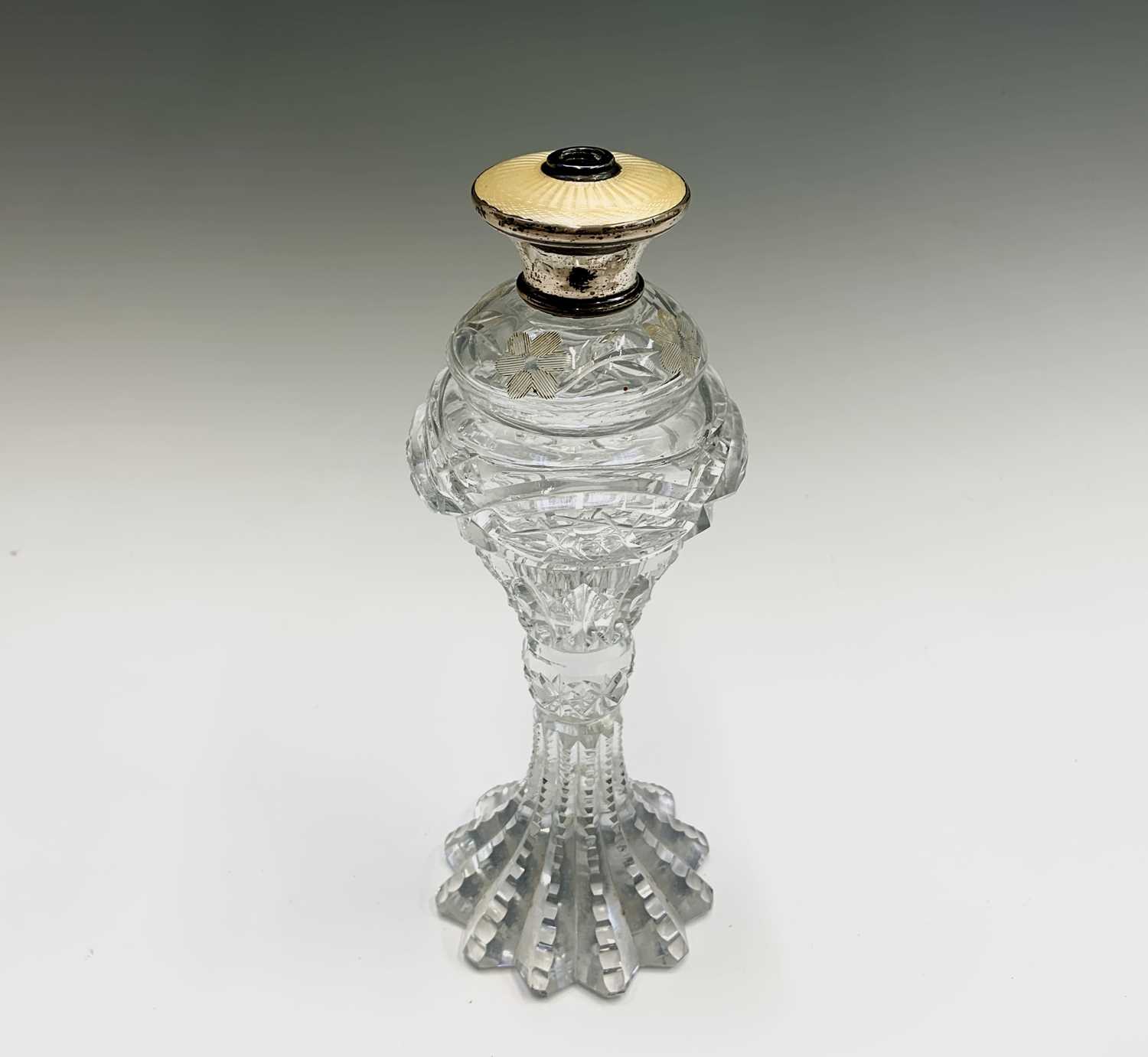 Lot 433 - A cut glass perfume bottle of elongated form,