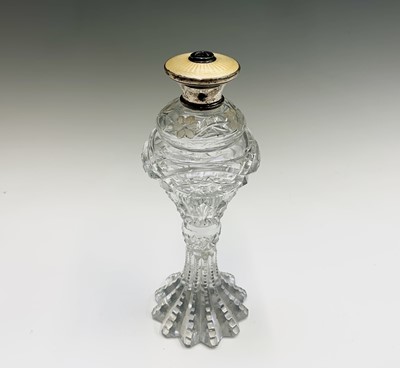 Lot 433 - A cut glass perfume bottle of elongated form,...