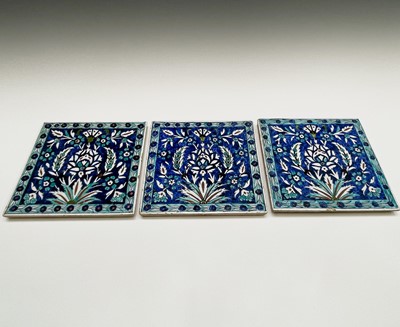 Lot 1056 - Three Iznik style pottery tiles, 20th century,...