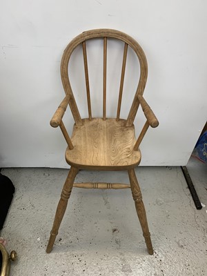 Lot 3287 - An elm hoop back high chair with turned arms,...