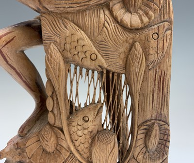 Lot 486 - An Eastern carved wood figure of a fisherman...