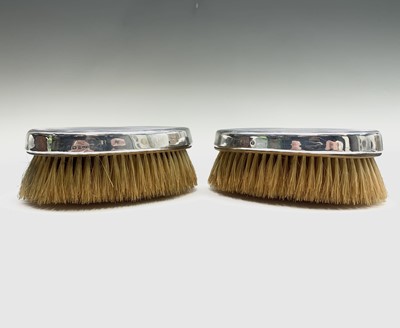 Lot 1050 - A pair of silver-mounted gentleman's brushes...