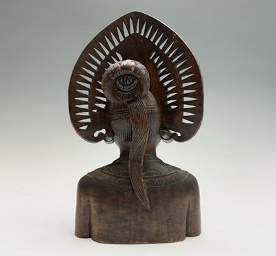 Lot 493 - A Balinese carved wood bust of a woman wearing...