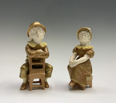 Lot 811 - A pair of Royal Worcester shot silk figures of...