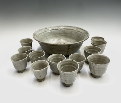 Lot 1101 - A studio pottery punch bowl and tumblers, the...