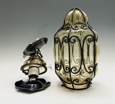 Lot 491 - A wrought iron and blown amber glass light...