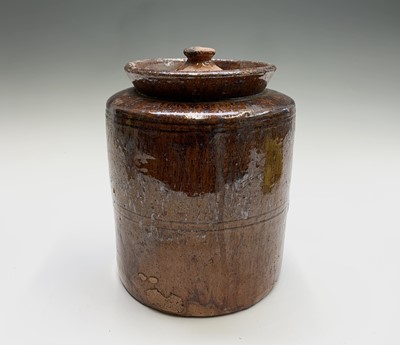 Lot 885 - A 19th century lidded earthenware jar, with...