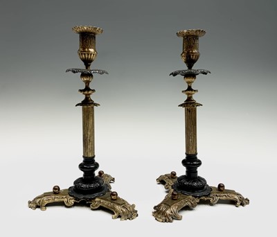 Lot 556 - A pair of Victorian ornate brass candlesticks,...