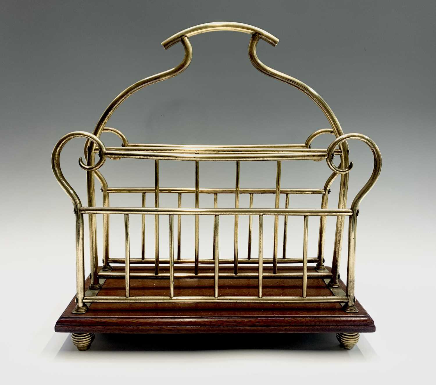Lot 347 - A brass and mahogany magazine rack. Height