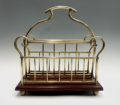 Lot 347 - A brass and mahogany magazine rack. Height...