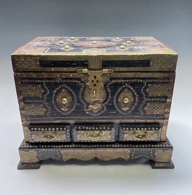 Lot 1013 - An Indian black painted and brass bound wood...