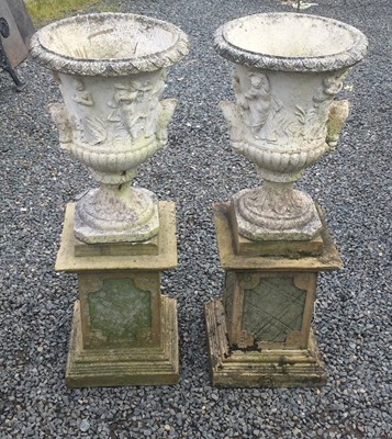 Lot 635 - A pair of reconstituted stone garden urns of...