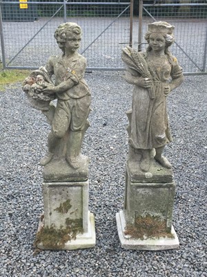 Lot 634 - A pair of reconstituted stone garden statues,...